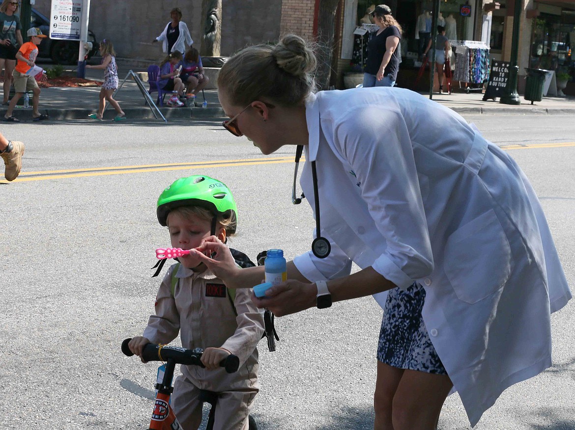 Dr. Kate Aguirre holds a bubble wand for son Asher, dressed as a rookie Ghostbuster, on Friday during the Kiddies Parade. Asher turns 3 years old today. Happy birthday, Asher!