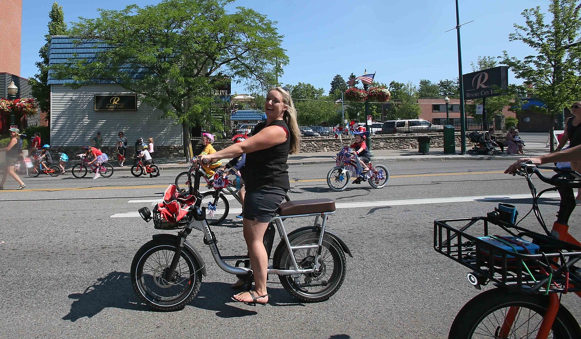 Children's Village interim CEO Vanessa Moos smiles for the camera Friday as she rolls along the Kiddes Parade route on Sherman Avenue.