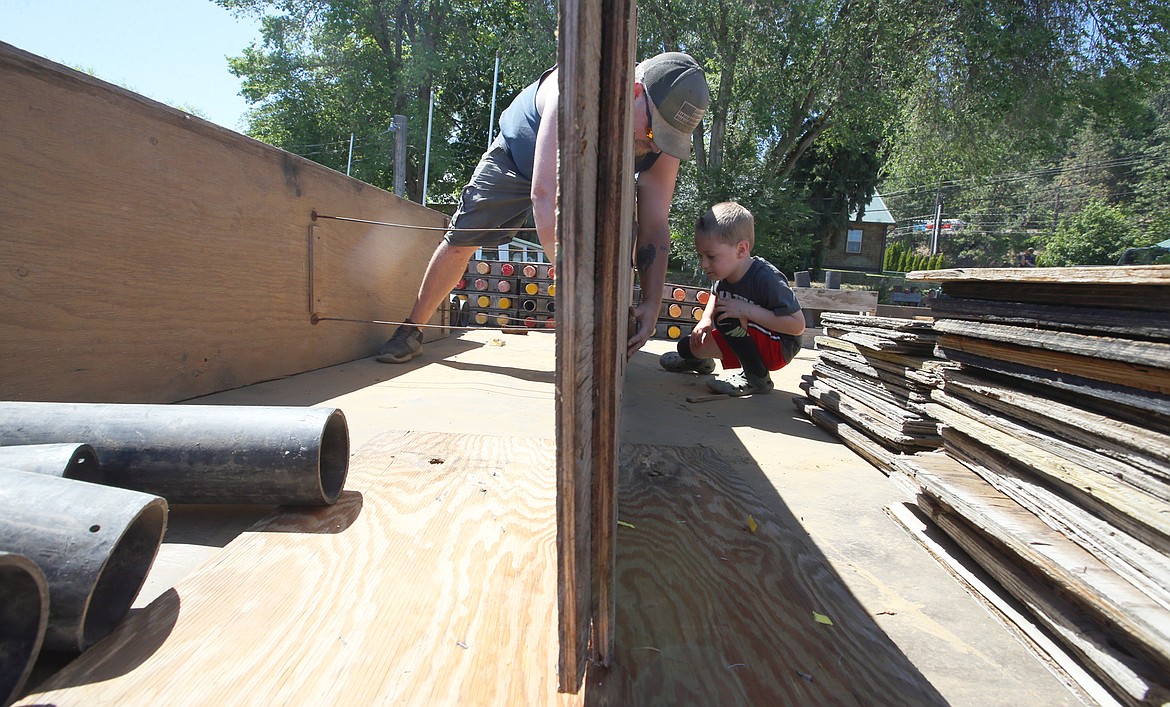 Dalton Vaughan of Pyro Spectaculars is joined by son Marshall at Murphy Marine on Friday as he prepares for the Fourth of July fireworks display over Lake Coeur d'Alene on Sunday.