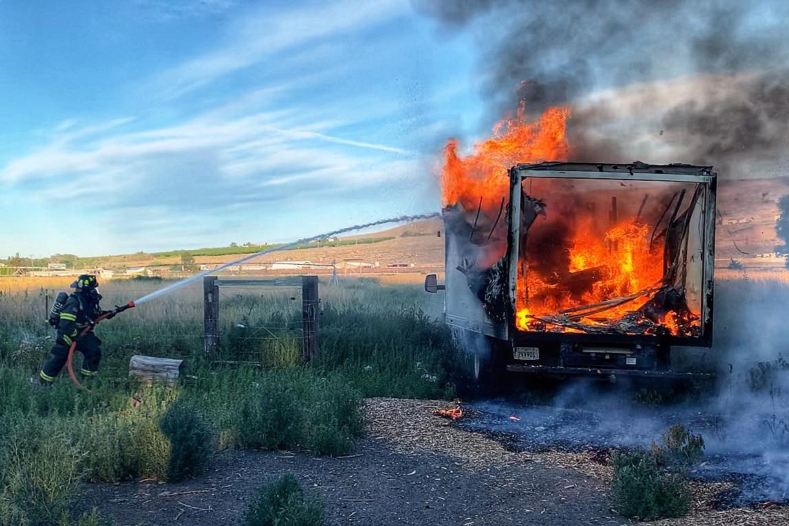 Firefighters control a fireworks truck fire early Sunday morning, south of Ephrata.