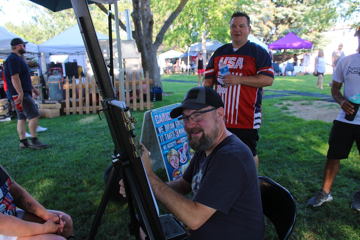 Caricature artist Shane Manahan draws Freedom Fest patrons on Saturday in Moses Lake.