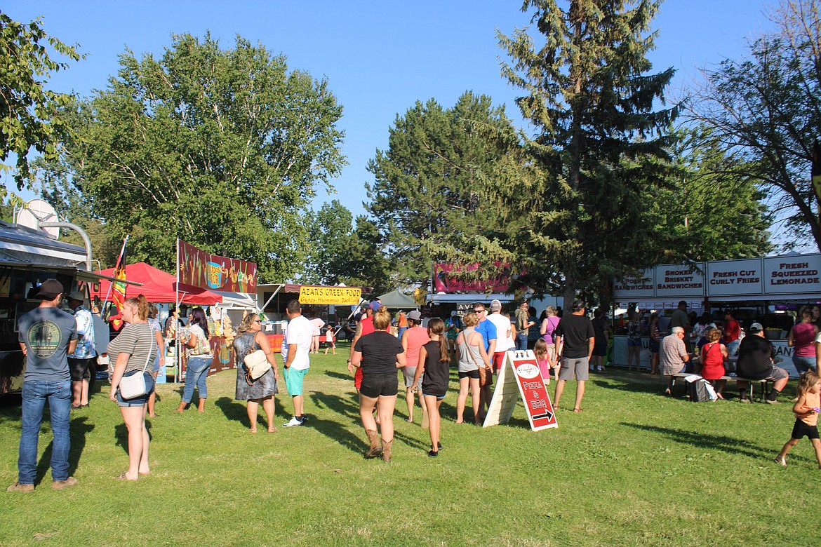 Freedom Festival attendees weigh their food options at McCosh Park in Moses Lake on Saturday.