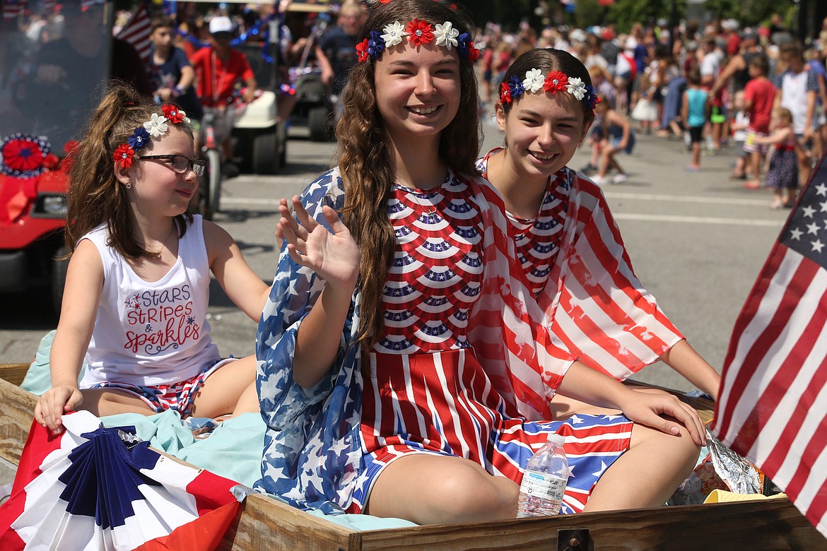 Ellie Stevens, left, and sisters Avery and Morgan Freeman were dressed for the occasion as they participate in Spirit Lake's Fourth of July parade on Sunday.