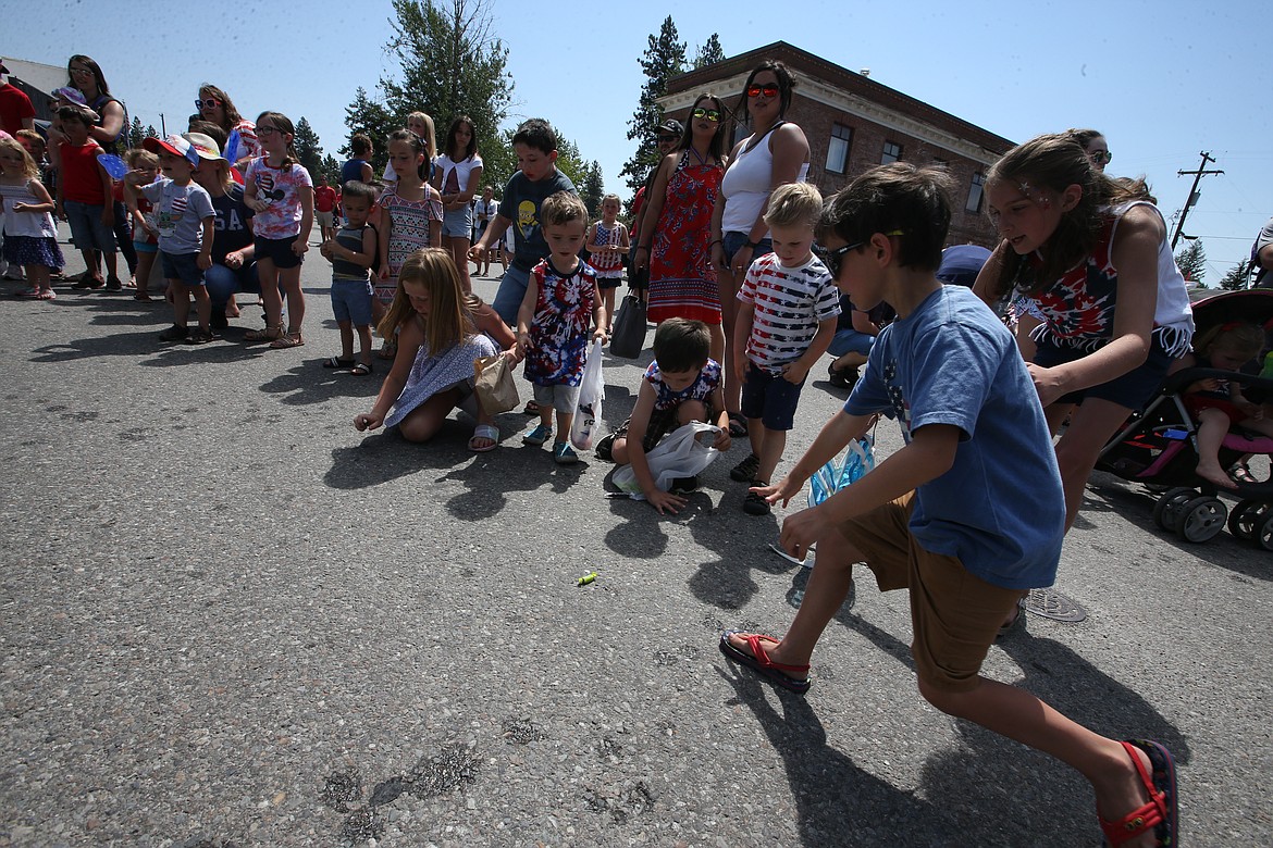 Kids rush after candy during Spirit Lake's Fourth of July parade.