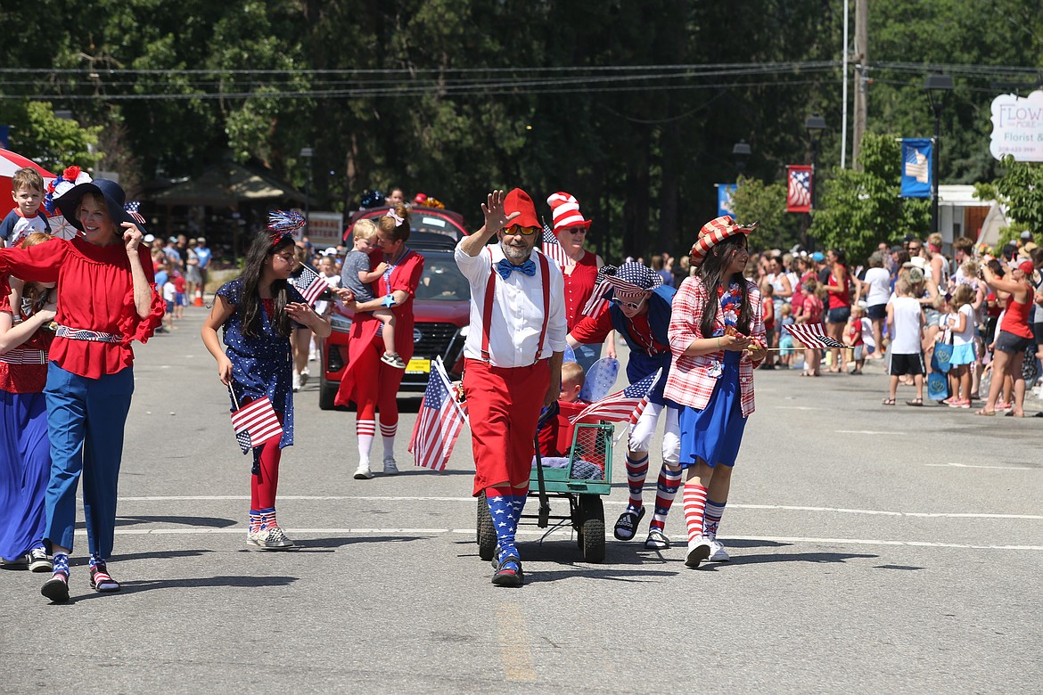 Paul Sturm waves during Spirit Lake's Fourth of July parade.