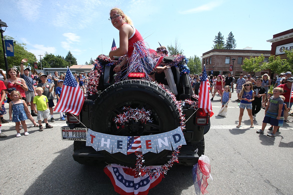 Angel Stubbs looks back as the final vehicle notes the end of Spirit Lake's Fourth of July parade.