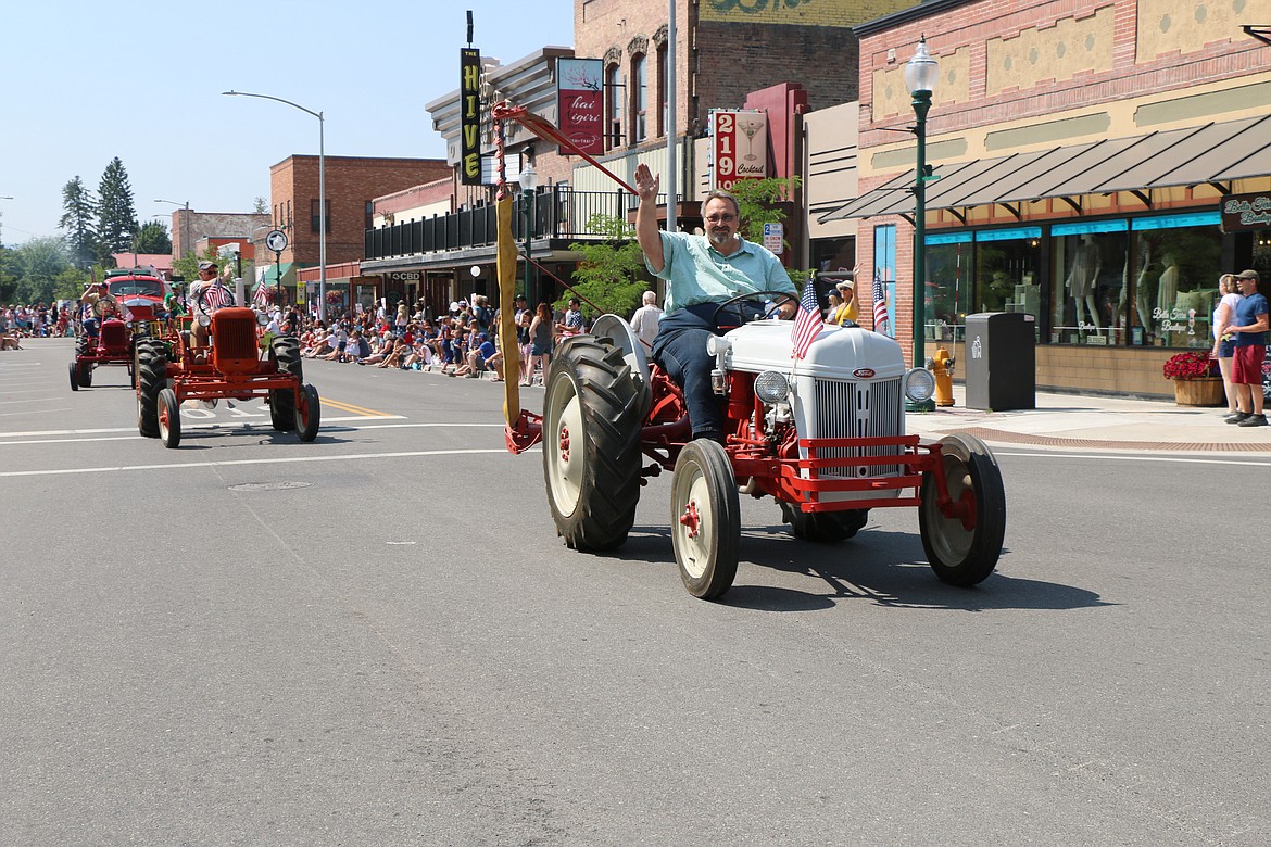 Antique and vintage tractor club members take part in the Fourth of July Grand Parade.