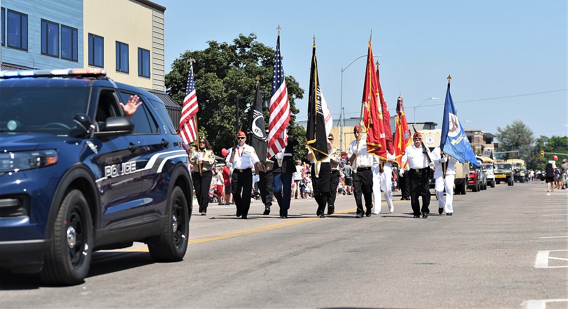 Polson Police Chief Wade Nash and the Mission Valley Honor Guard lead the parade down Main Street. (Scot Heisel/Lake County Leader)