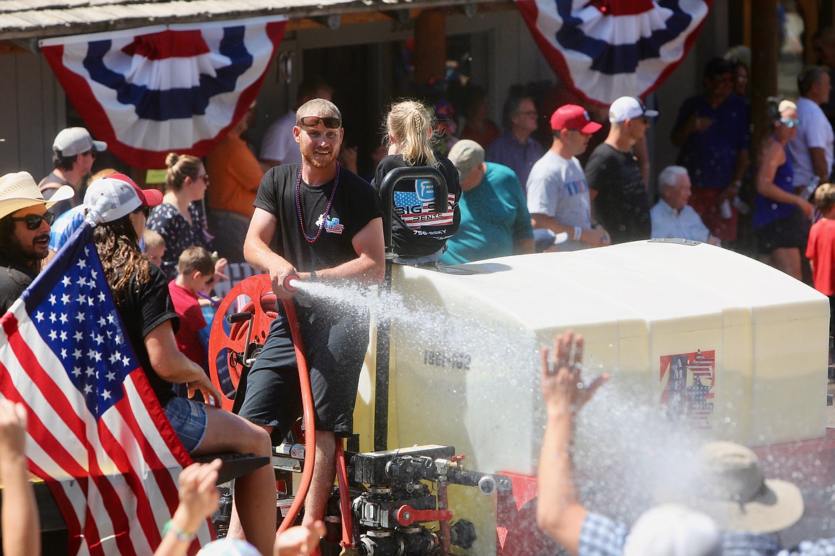 A man Big Sky Rentals smiles as he sprays the crowd with water during the Bigfork Fourth of July Parade.
Mackenzie Reiss/Bigfork Eagle