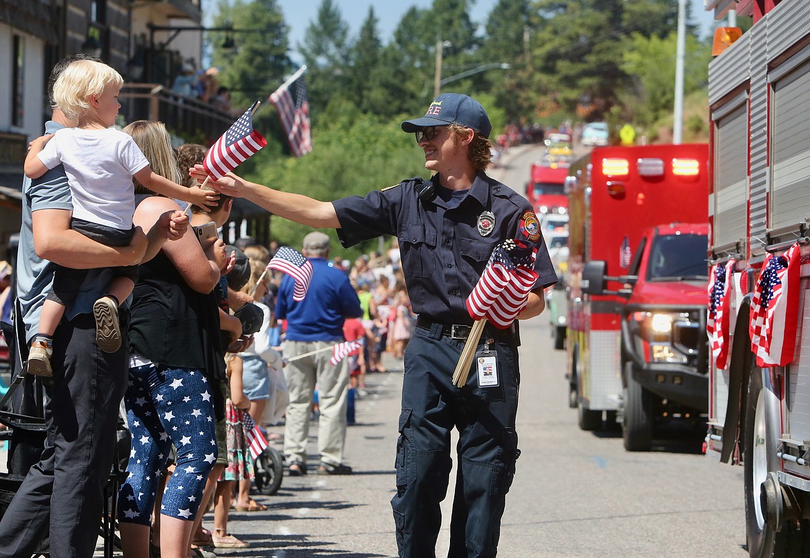 A Bigfork Fire Department firefighter passes out American flags during the Bigfork Fourth of July Parade.
Mackenzie Reiss/Bigfork Eagle