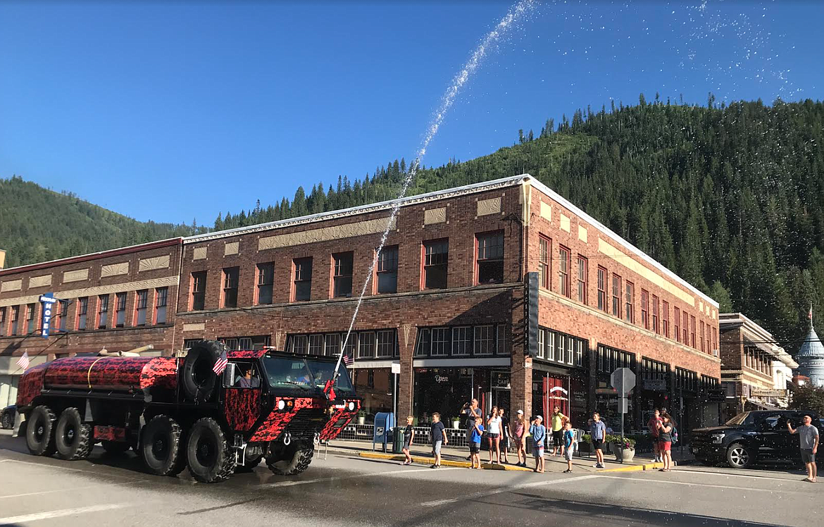 The Mullan Volunteer Fire Department water tender lets loose with its water cannon during the Statehood Day Parade on Saturday.