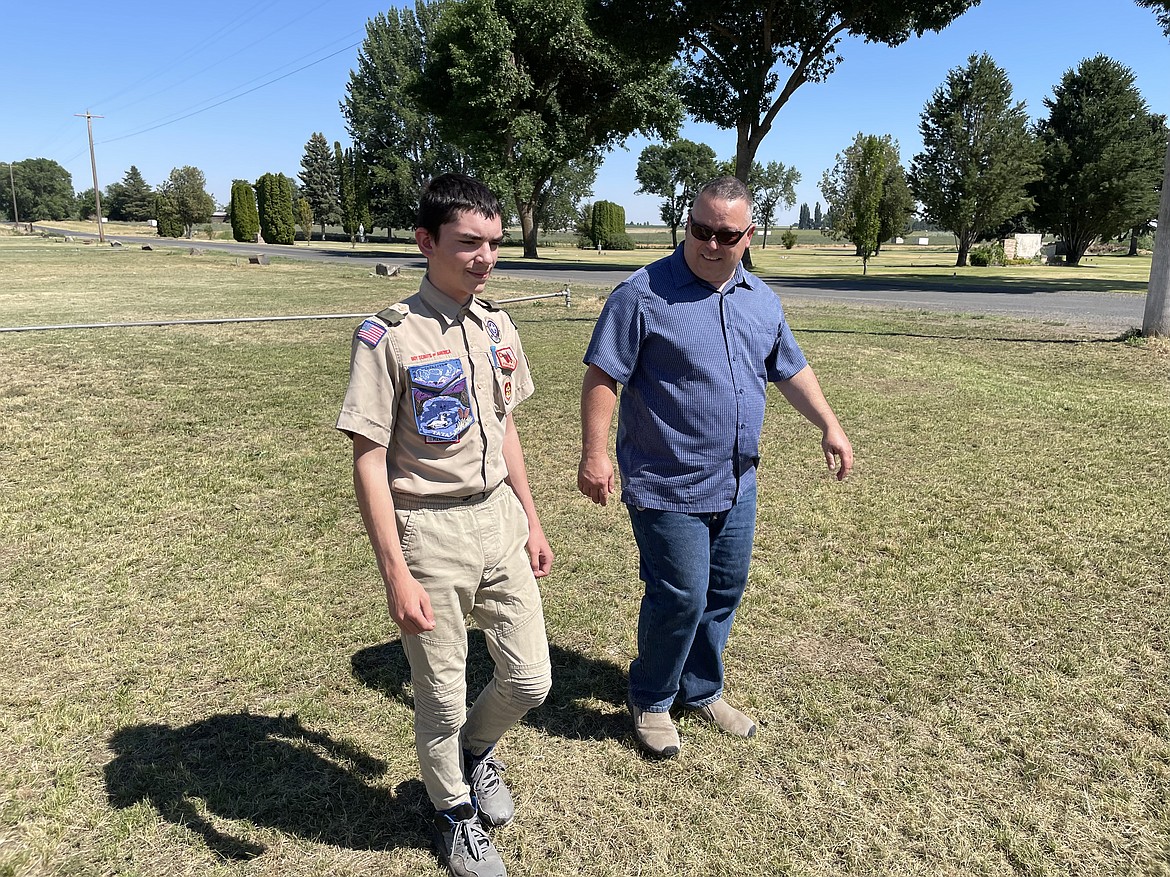 Chance Morris and his father Justin, who is also the Scoutmaster of Troop 777, walk outside the chapel at Pioneer Memorial Gardens.