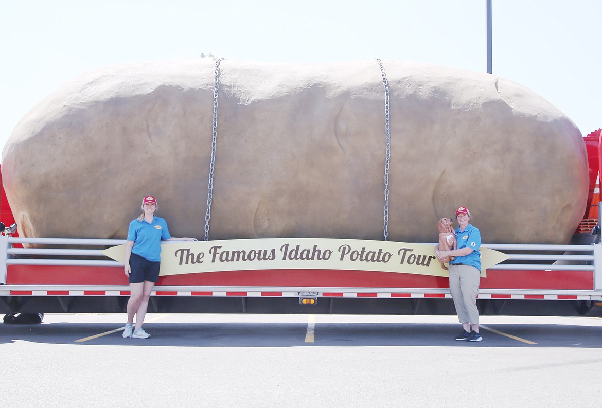 Kaylee Wells, left, and Melissa Bradford, stand in front of the Great Big Idaho Potato on Tuesday in front of Oldtown Super 1. This year, the gigantic spud will travel down the west coast on its way to Texas. Visit potatotracker.com to keep up with this tuber's summer adventure.