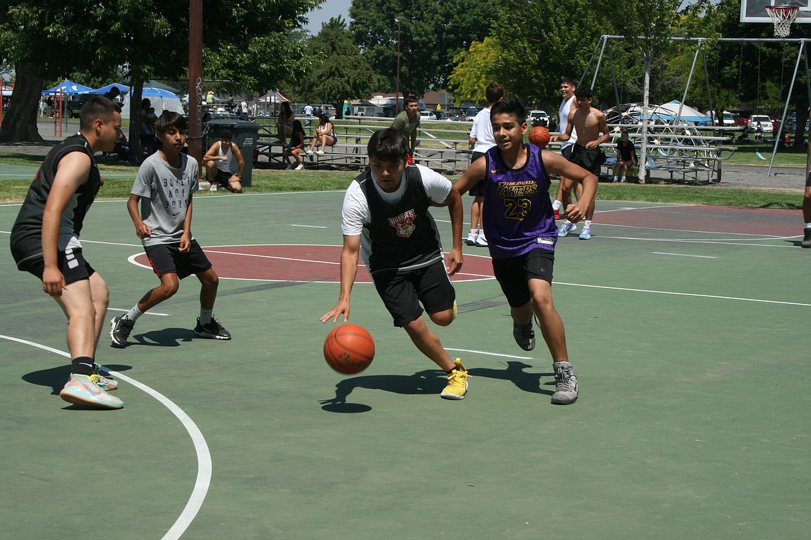 A player drives to the basket during the three-on-three basketball tournament on Saturday in Othello.