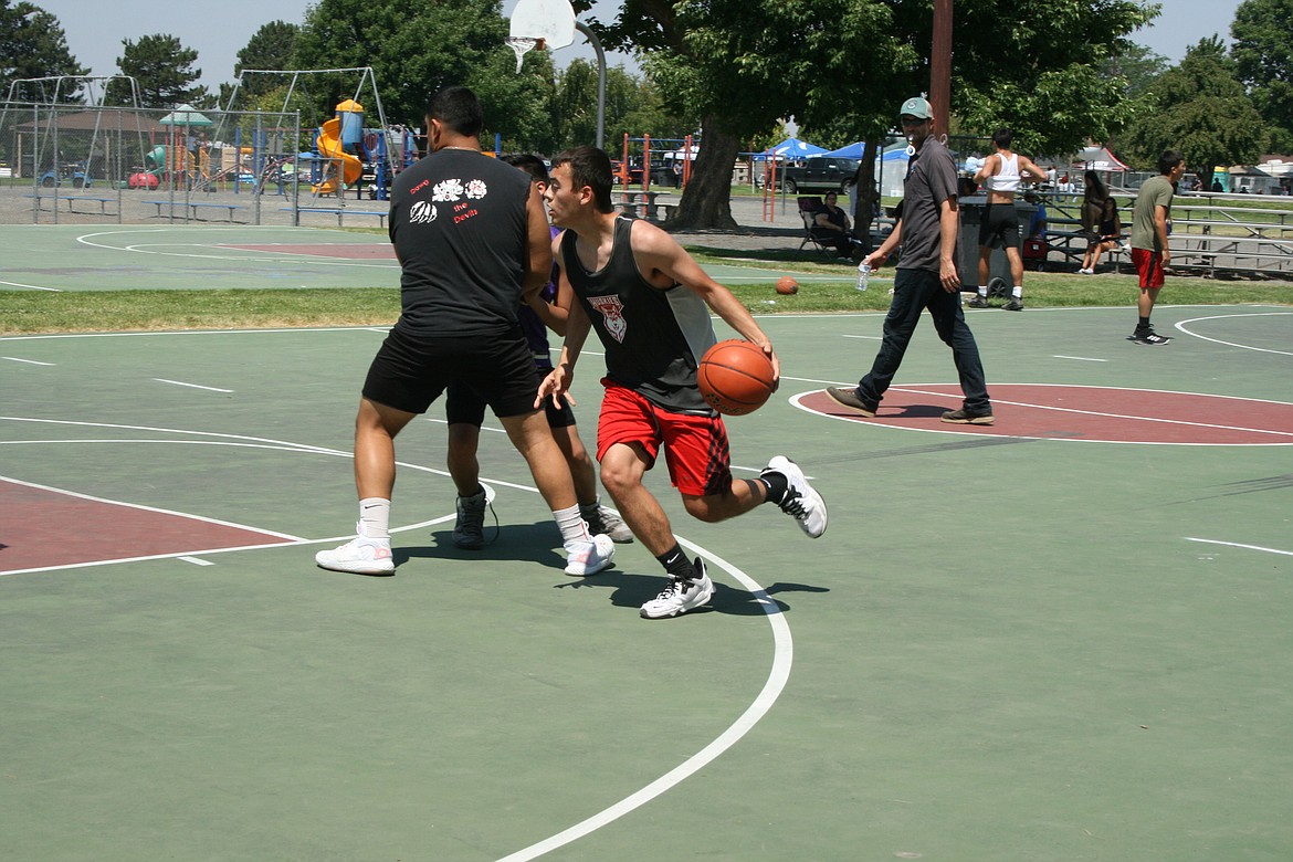 A player takes advantage of a screen at the three-on-three basketball tournament Saturday at the Independence Day celebration in Othello.