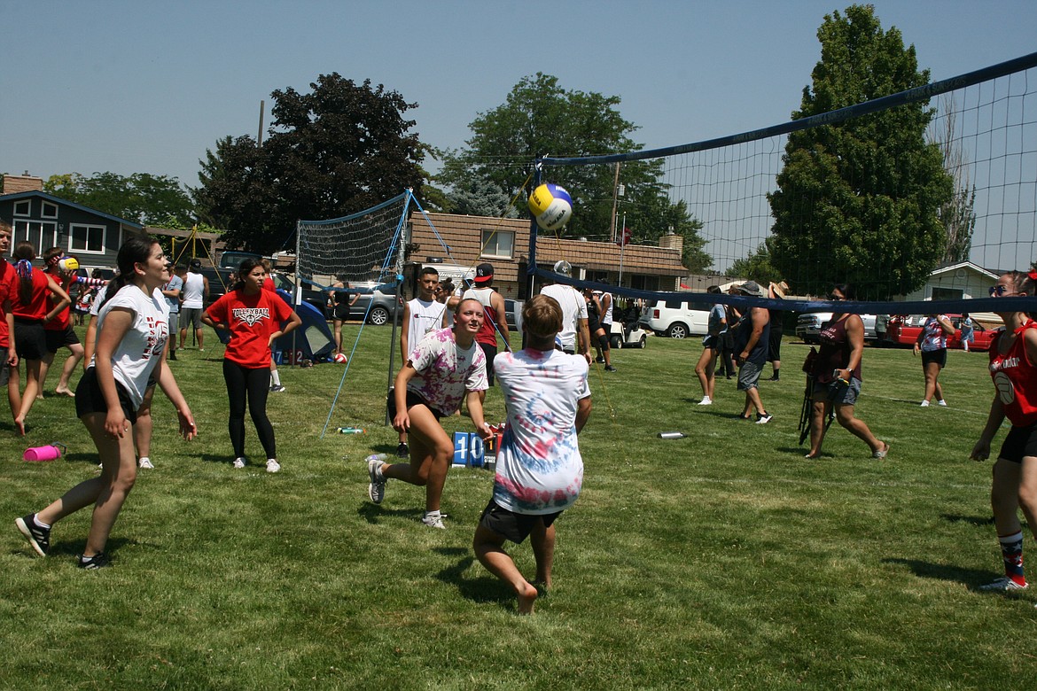 Teammates work to return the ball during the volleyball tournament at the Independence Day celebration on Saturday in Othello.