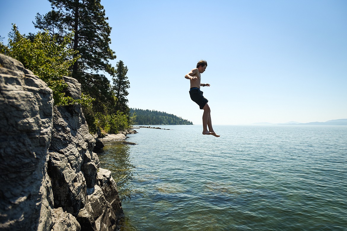 Makoa Aneca, of Bigfork, jumps into Flathead Lake from a cliff at the Wayfarers Unit of Flathead Lake State Park in Bigfork on Tuesday, June 29, 2021. (Casey Kreider/Daily Inter Lake)