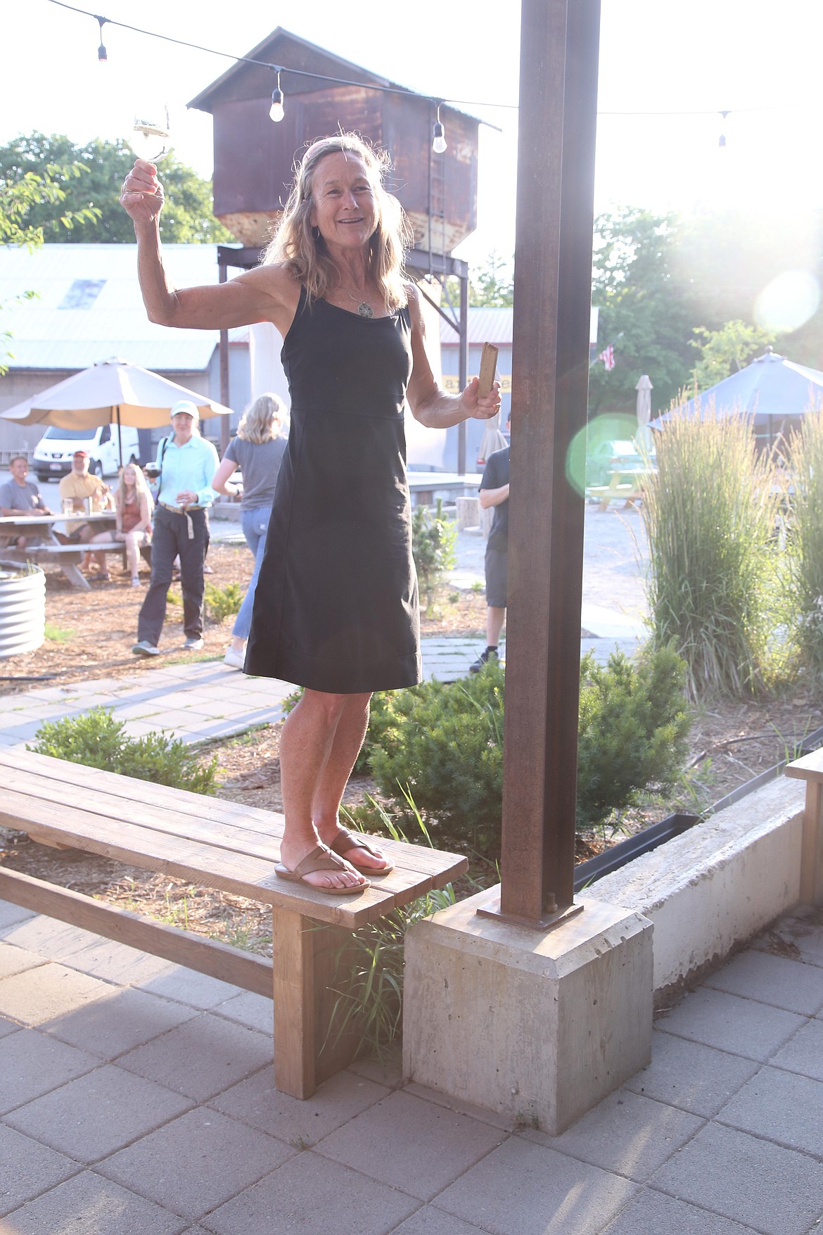 Julie Meyer, president of Pend Oreille Pedalers, holds a toast at Matchwood Brewing to celebrate Sandpoint city council's approval to build 2.4 miles of new trail in the Little Sand Creek Watershed.