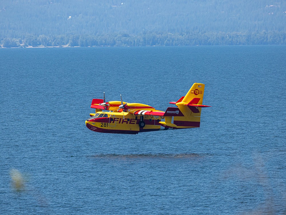A plane gathering water to fight the Trestle Creek fires.