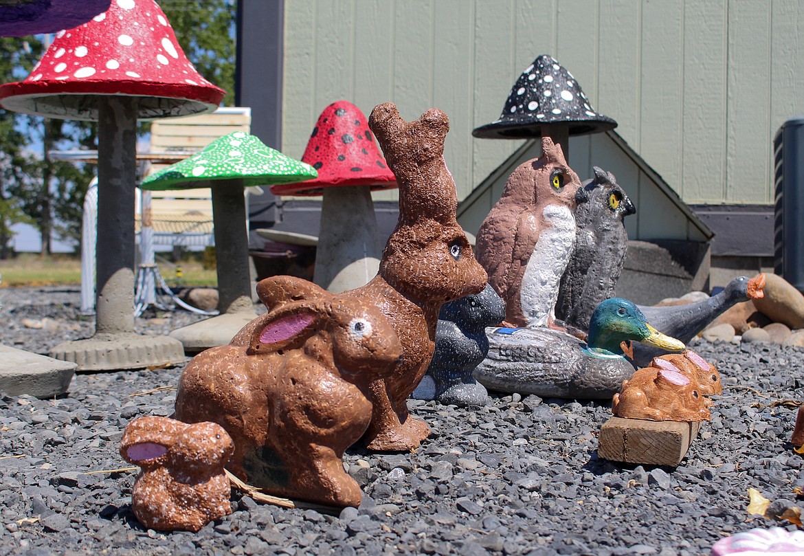 Custom-crafted animal statues are lined up outside the back door of Joan Lewis’ home in Moses Lake on Wednesday.