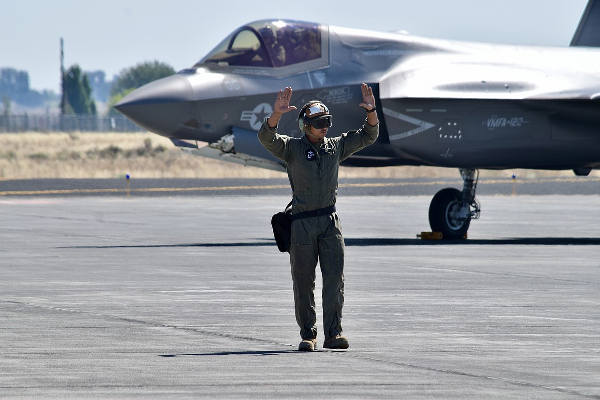 A Marine Corps ground controller guides an F-35 Lightning II into position for refueling during a training exercise Thursday.