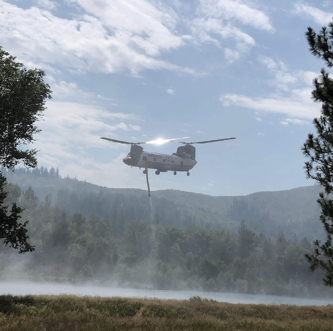 A firefighting Chinook helicopter assists with suppression efforts.