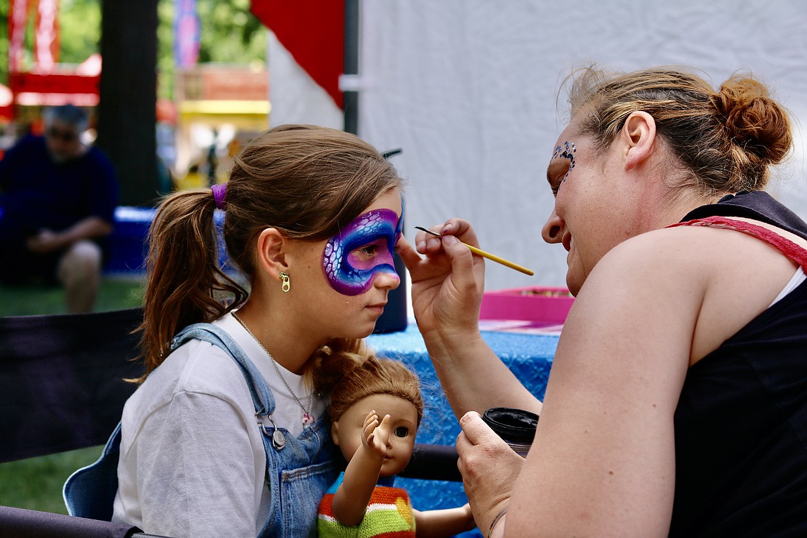 Trisha Owens of Sugar Mama's Face Painting paints gives Madison Reeder, 9, of Coeur d'Alene a new look at her first visit to the Post Falls Festival on Friday. HANNAH NEFF/Press