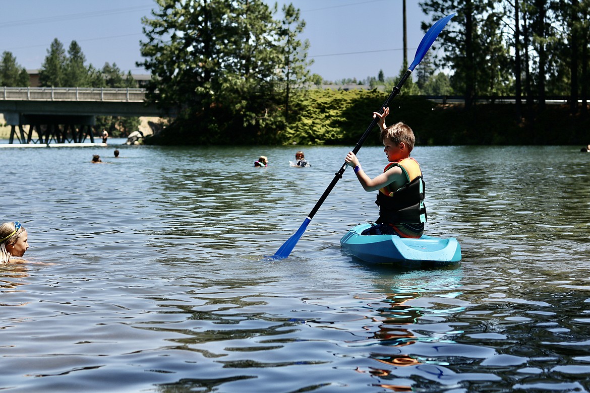 Kryon Dyer, 8, of Post Falls takes a kayak out on the Spokane River at Q'emiln Park at the Post Falls Festival on Friday. HANNAH NEFF/Press
