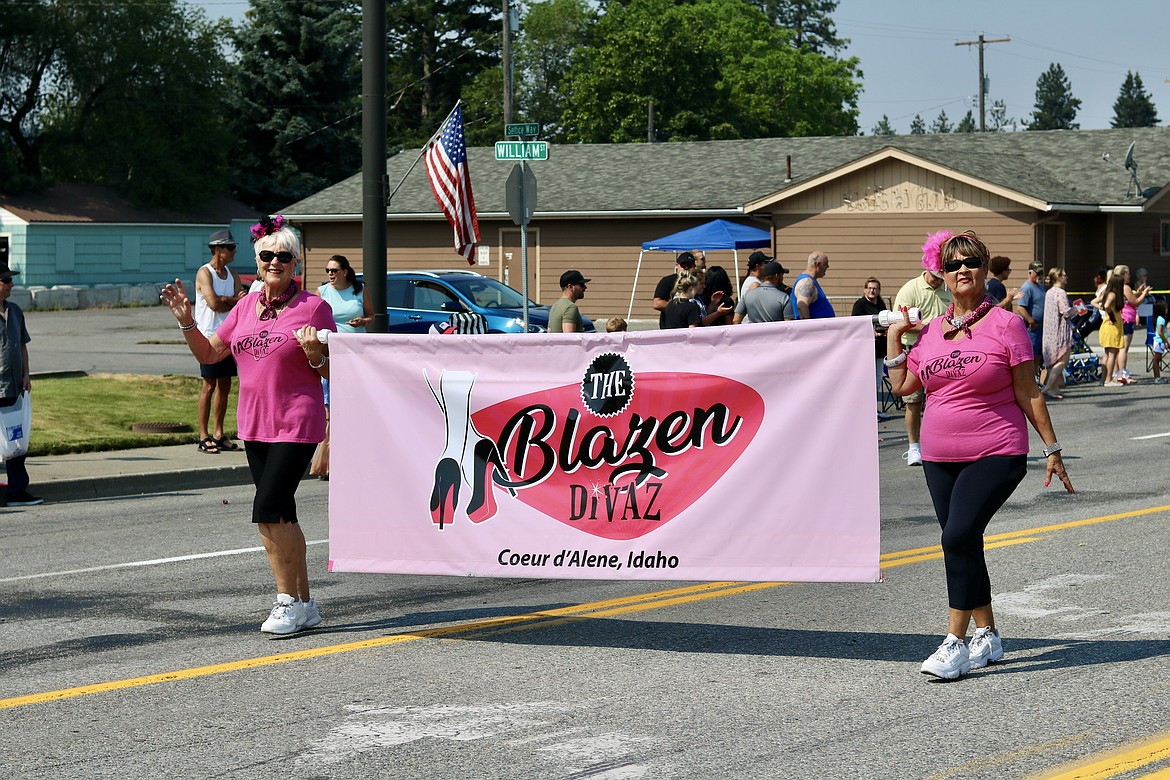 Patricia Richardson, left, and Nancy Grisom lead the Blazen Divaz up Seltice Way at the Post Falls Festival parade Saturday morning. HANNAH NEFF/Press