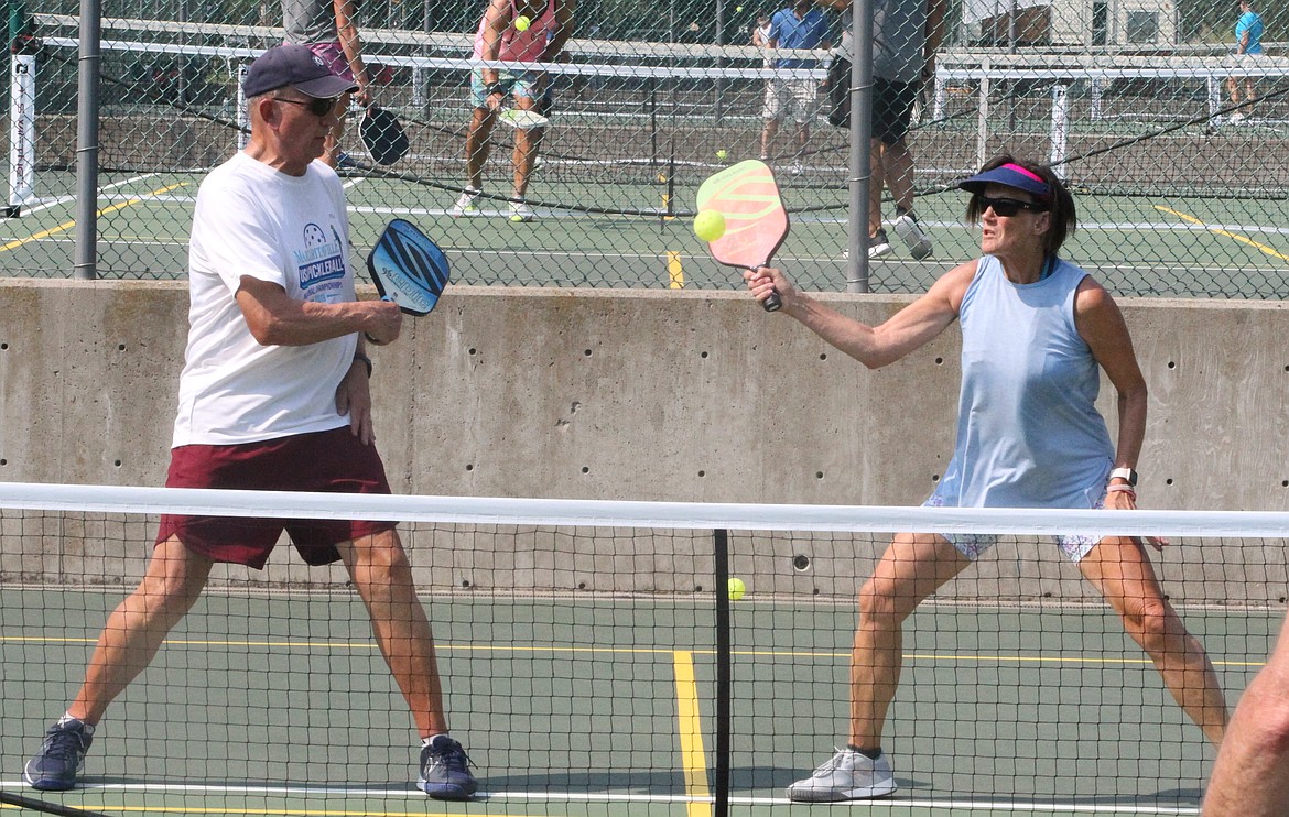 MARK NELKE/Press
Julie Billetz, right, of Post Falls, reaches for a shot as Glenn Graf of Mount Pleasant, Iowa looks on in the gold medal match in the mixed doubles 4.0 60-plus division at the Coeur d'Alene Classic pickleball tournament Saturday at Cherry Hill Park. The four-day tournament, which attracted 314 entrants, began Thursday with women's doubles, continued Friday and Saturday with mixed doubles brackets, and concludes today with men's doubles. Play today begins at 8 a.m., and figures to run through mid- to late-afternoon.