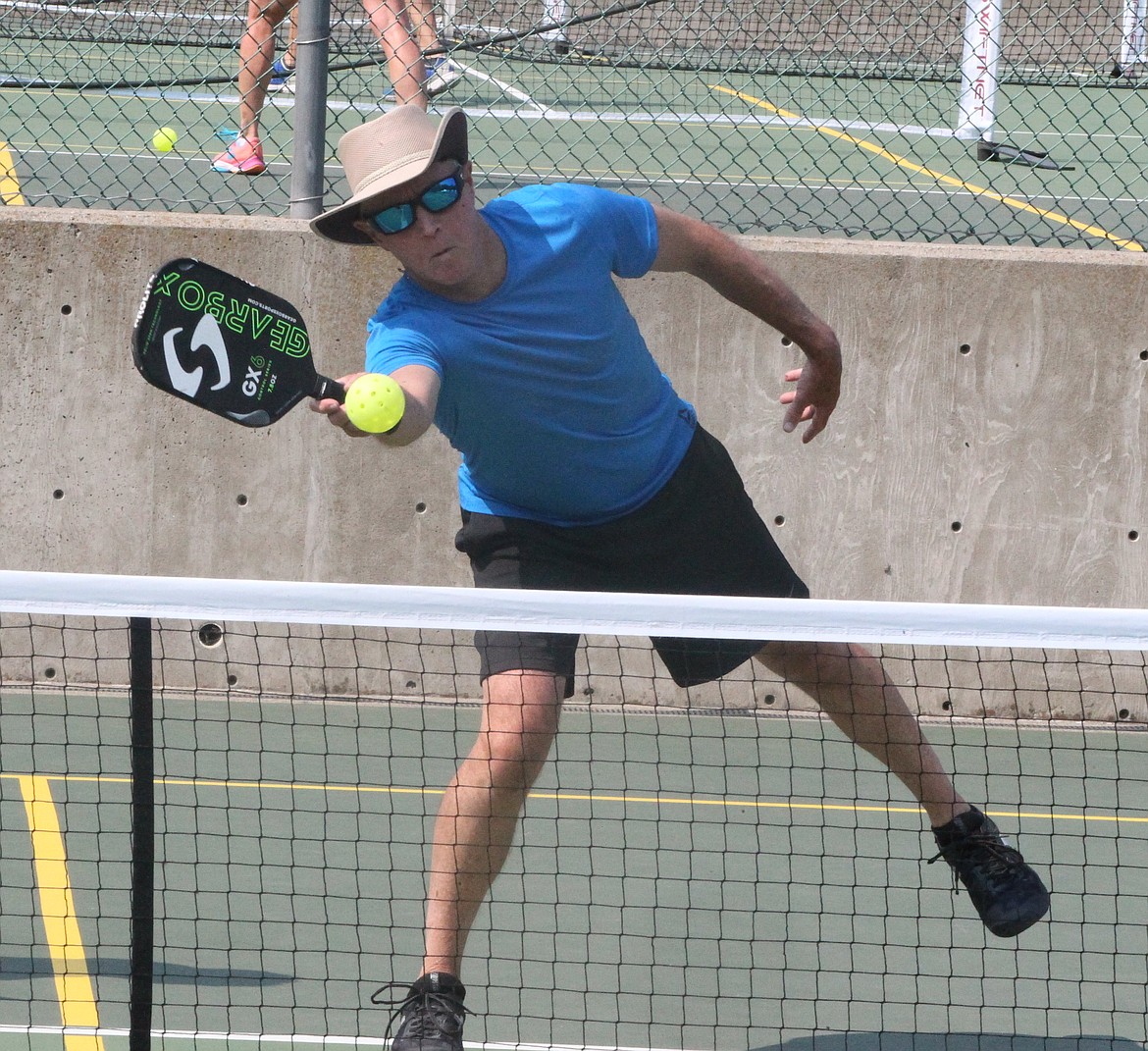 MARK NELKE/Press
Jeff Schmitt, of Priest Lake and formerly of Coeur d'Alene, reaches for a shot in the gold medal match in the mixed doubles 4.0 60-plus division at the Coeur d'Alene Classic pickleball tournament Saturday at Cherry Hill Park. The four-day tournament, which attracted 314 entrants, began Thursday with women's doubles, continued Friday and Saturday with mixed doubles brackets, and concludes today with men's doubles. Play today begins at 8 a.m., and figures to run through mid- to late-afternoon.