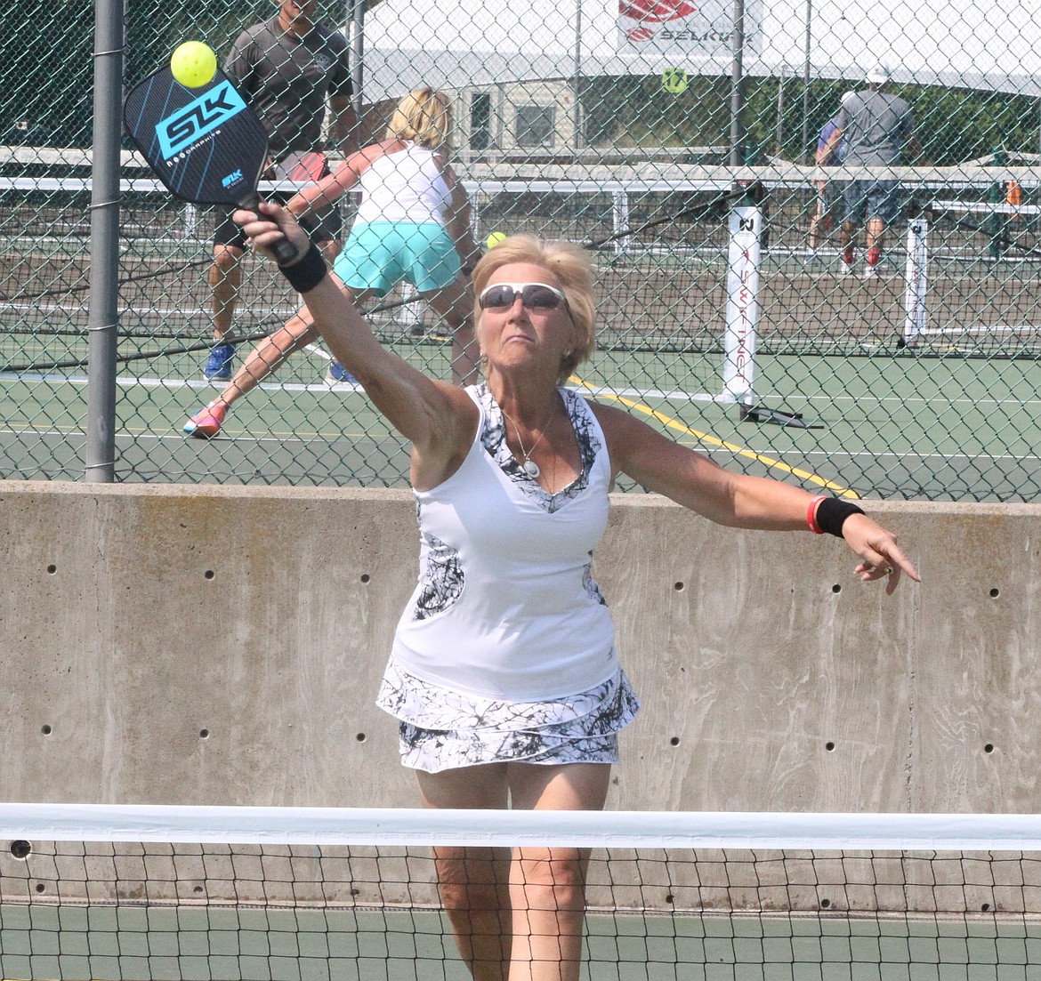 MARK NELKE/Press
Becky Yates of Post Falls hits an overhead in the gold medal match in the mixed doubles 4.0 60-plus division at the Coeur d'Alene Classic pickleball tournament Saturday at Cherry Hill Park. The four-day tournament, which attracted 314 entrants, began Thursday with women's doubles, continued Friday and Saturday with mixed doubles brackets, and concludes today with men's doubles. Play today begins at 8 a.m., and figures to run through mid- to late-afternoon.