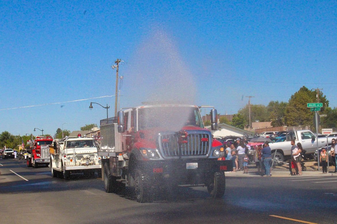 Grant County Fire District 10 cools off the crowd at the Royal City Summerfest parade on Saturday.