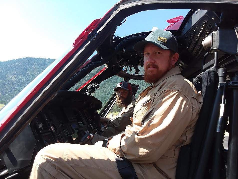 Clayton Cochran, front, and Ben Smith operate a 1980 Blackhawk helicopter as part of a Northern Rockies Type 1 incident team which is battling several wildfires in Mineral and Sanders counties. (Monte Turner/Mineral Independent)