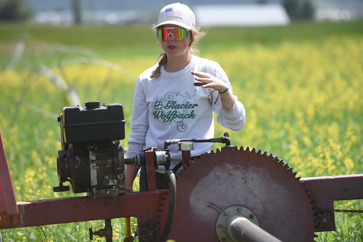Glacier High School student Ariah Thomas takes a break from fixing a motor on a water irrigation system to talk about some of the work she was hired to do at the H.E. Robinson Agricultural Education Center working farm while school is out for summer on Tuesday, June 22, 2021. Thomas is one of three students hired to keep up the farm while school is out for summer. (Scott Shindledecker/Daily Inter Lake)