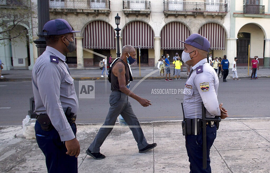 Police stand guard near the National Capitol building in Havana, Cuba, Monday, July 12, 2021, the day after protests against food shortages and high prices amid the coronavirus crisis. (AP Photo/Ismael Francisco)