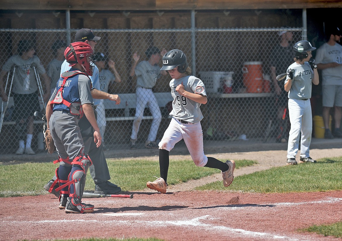 Whitefish player Carter Godsey runs across home base to score a run in a baseball game Friday against Mission during the Cal Ripken 12U Montana State Tournament in Whitefish. (Whitney England/Whitefish Pilot)