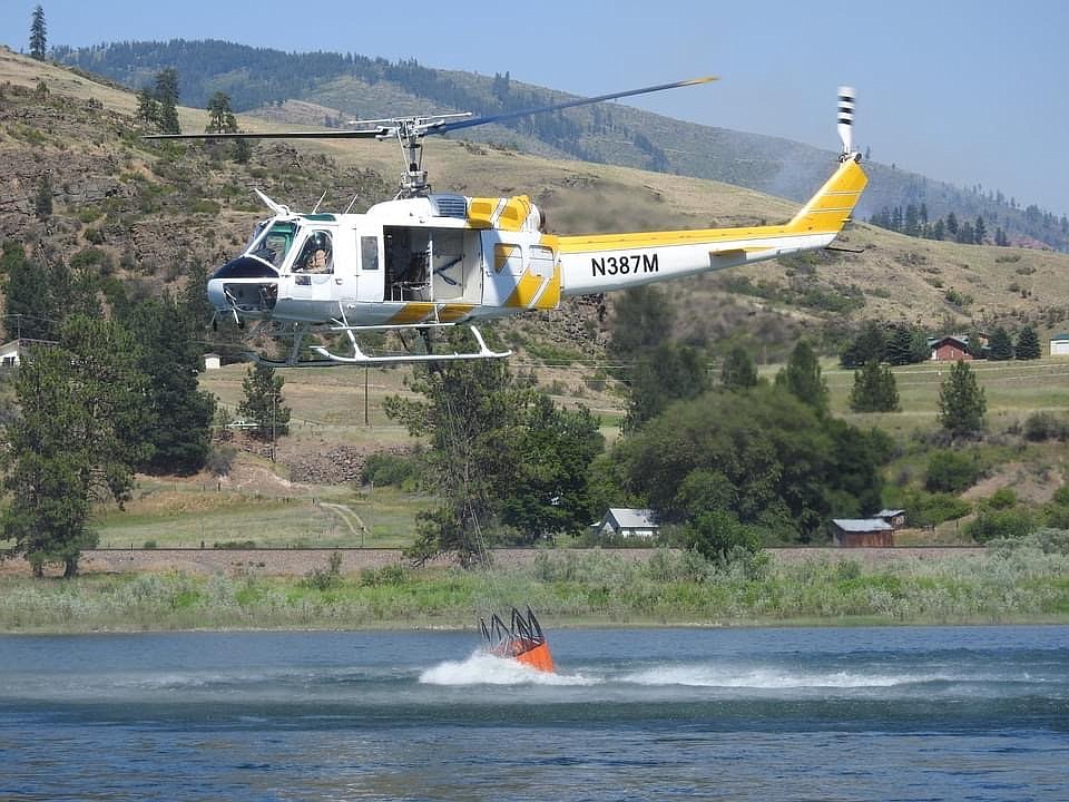 A helicopter picks up water from the Clark Fork River to help fight the Henry Creek Fire near Plains on Sunday, July 11, 2021. Sanders County officials announced that Stage II fire restrictions will go into effect Saturday, July 17, 2021. (Courtesy of Michael Tatum)