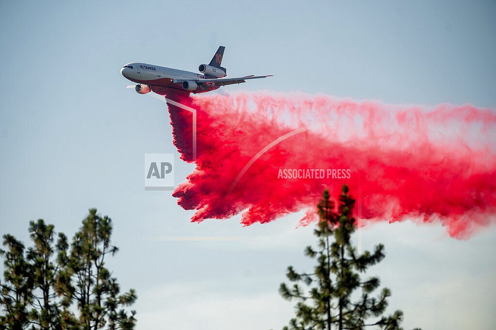 In this July 2, 2021, file photo a DC-10 air tanker drops retardant while battling the Salt Fire near the Lakehead community of Unincorporated Shasta County, Calif. Airport officials facing jet fuel shortages are concerned they'll have to wave off fire retardant bombers and helicopters when wildfire season heats up, potentially endangering surrounding communities. (AP Photo/Noah Berger, File)