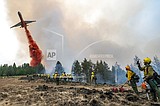Thousands of firefighters battle big blazes across the West