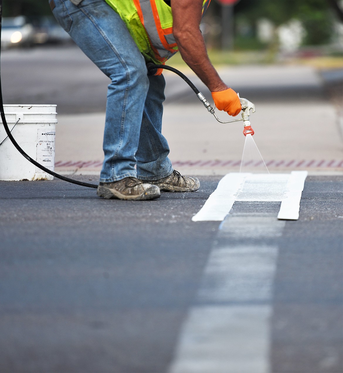 A state Department of Transportation crew repainted several crosswalks along Main Street in Polson on Friday. (Scot Heisel/Lake County Leader)