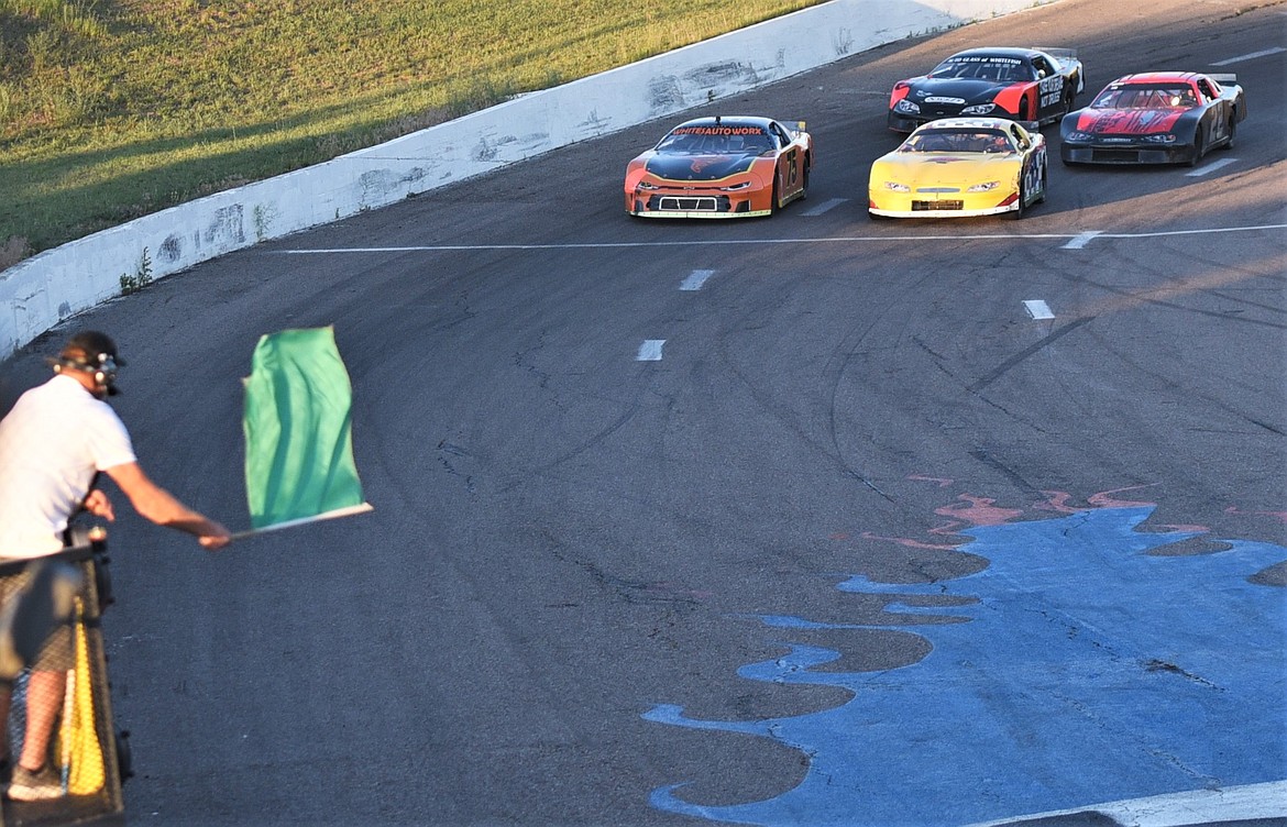 Mission Valley Super Oval operator Tony Undem waves the green flag to start a late model race on July 3. (Scot Heisel/Lake County Leader)