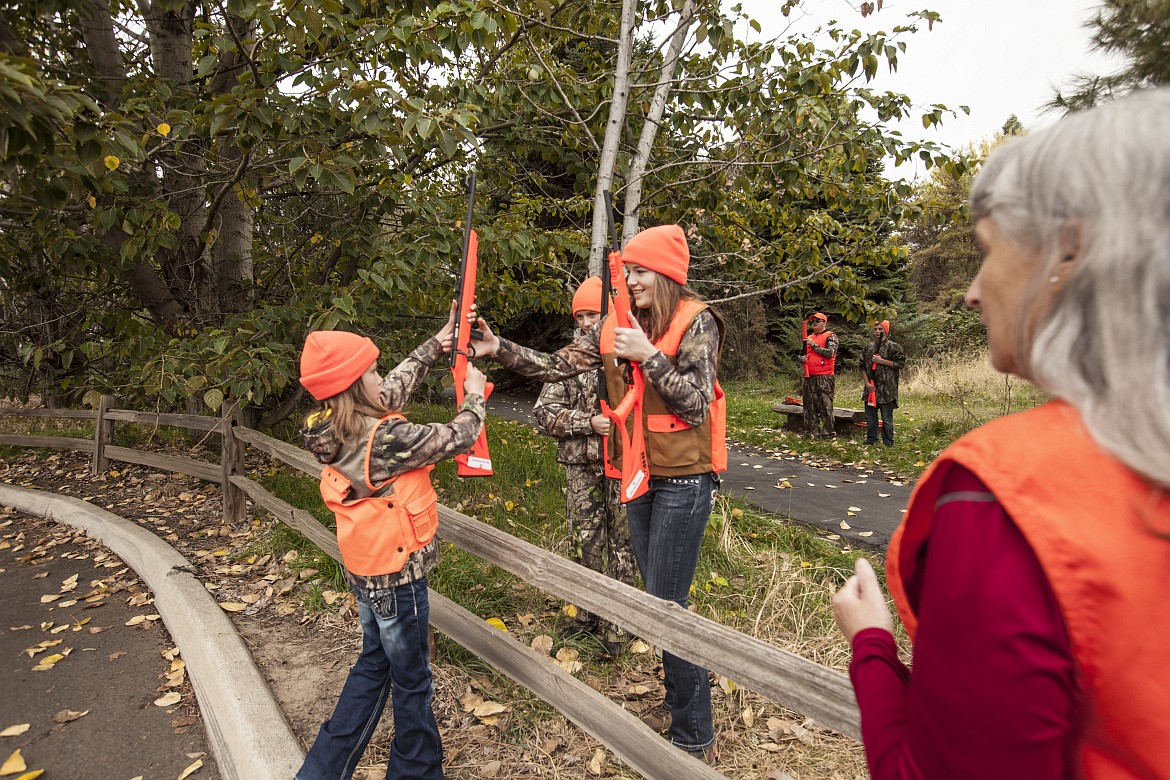 Phhoto by Glenn Oakley
Jill Green watches as two girls cross over a fence during a past hunter education class.