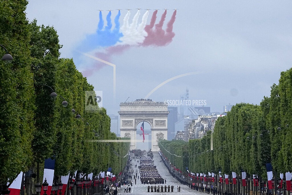 Jets of the Patrouille de France fly over the Champs-Elysees avenue during the Bastille Day parade, Wednesday, July 14, 2021 in Paris. France is celebrating its national holiday with thousands of troops marching in a Paris parade and traditional parties around the country, after last year's events were scaled back because of virus fears. (AP Photo/Michel Euler, Pool)