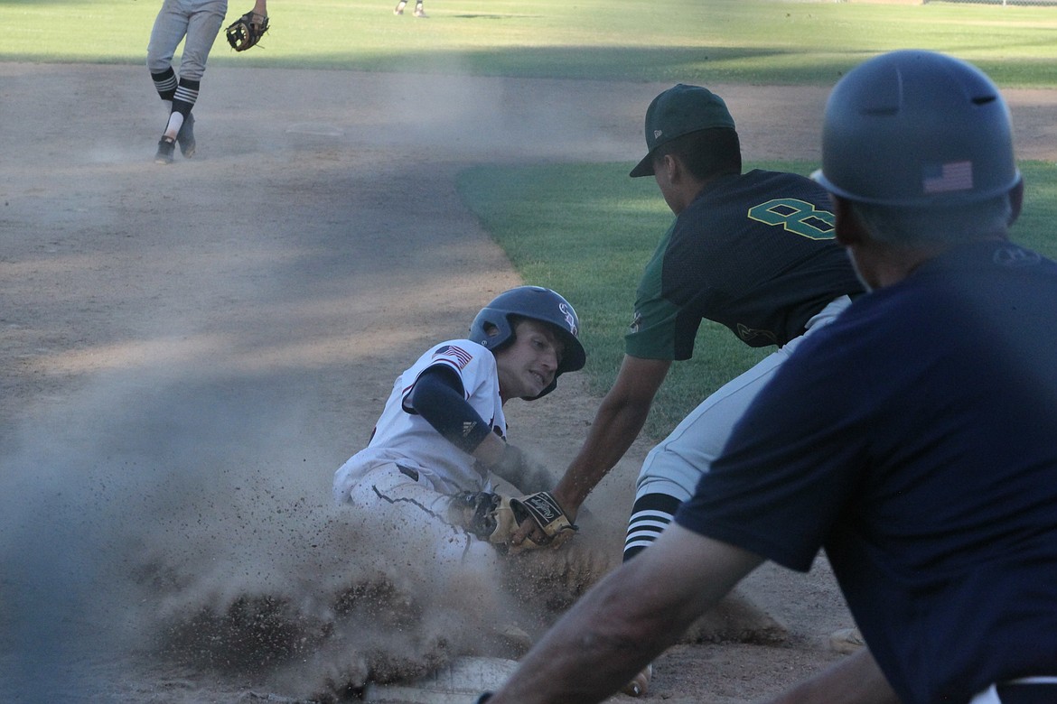 JASON ELLIOTT/Press
Coeur d'Alene Lumbermen shortstop Marcus Manzardo attempts to slide under the tag of Lewis-Clark third baseman Jose Barajas in the sixth inning of Thursday's game at Thorco Field.