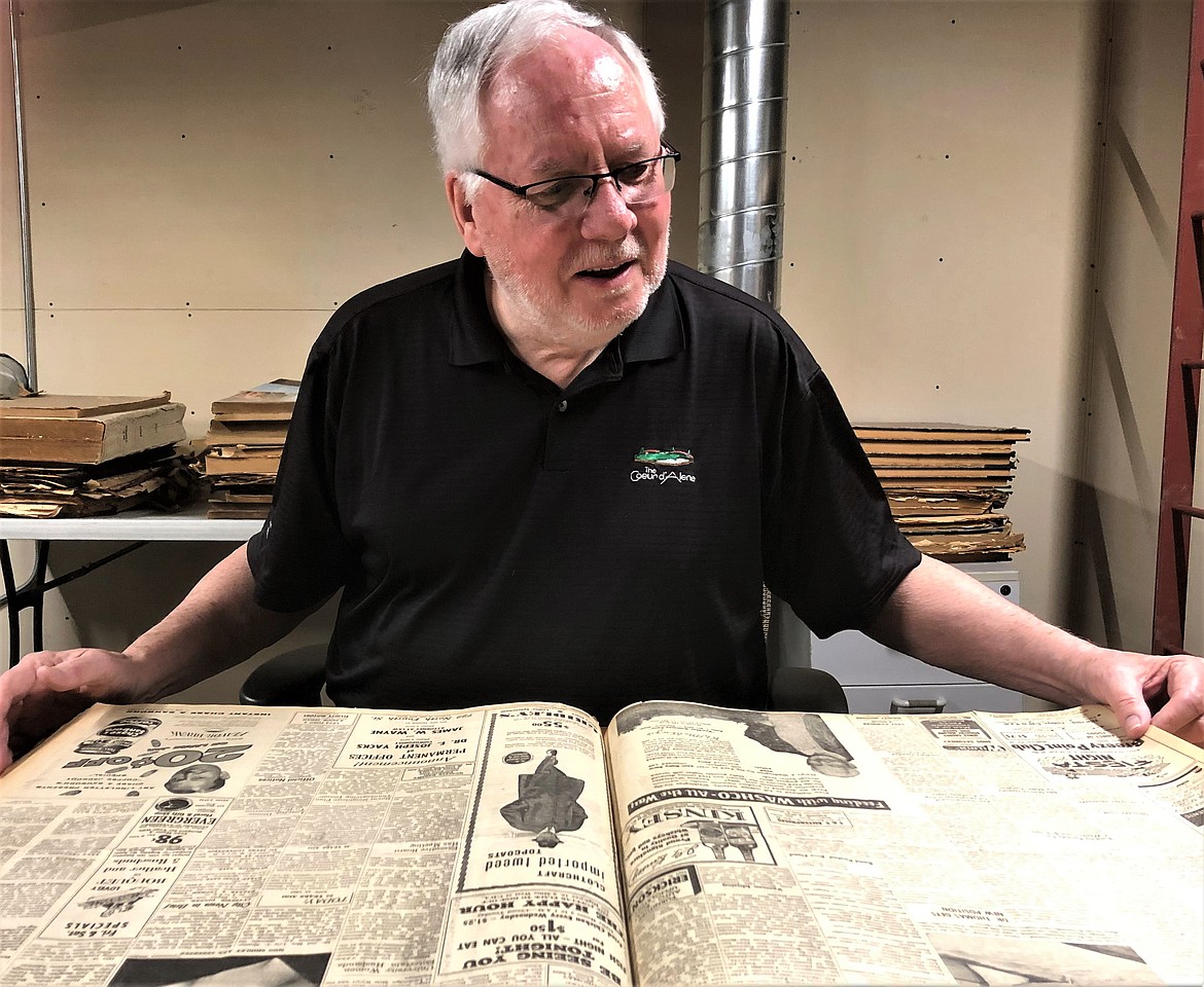 Tom Cronin poring through old Coeur d'Alene Press editions.
MIKE PATRICK/Press