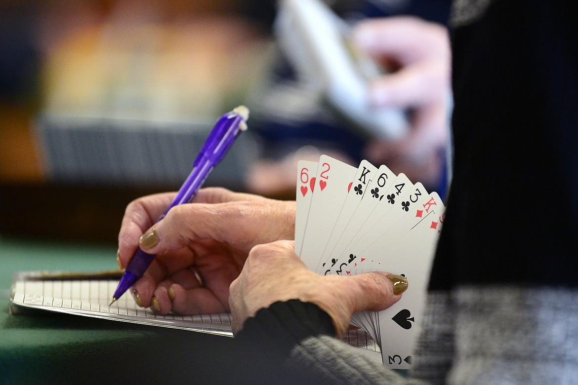 A player makes note of a bid during a game of bridge at the Flathead Valley Bridge Center on Friday, March 6. (Casey Kreider/Daily Inter Lake)