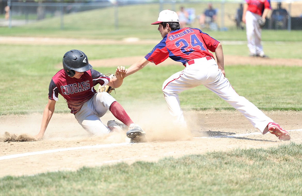 Chase Sanroman tries to tag out a Whitman County base runner at third base on Friday.