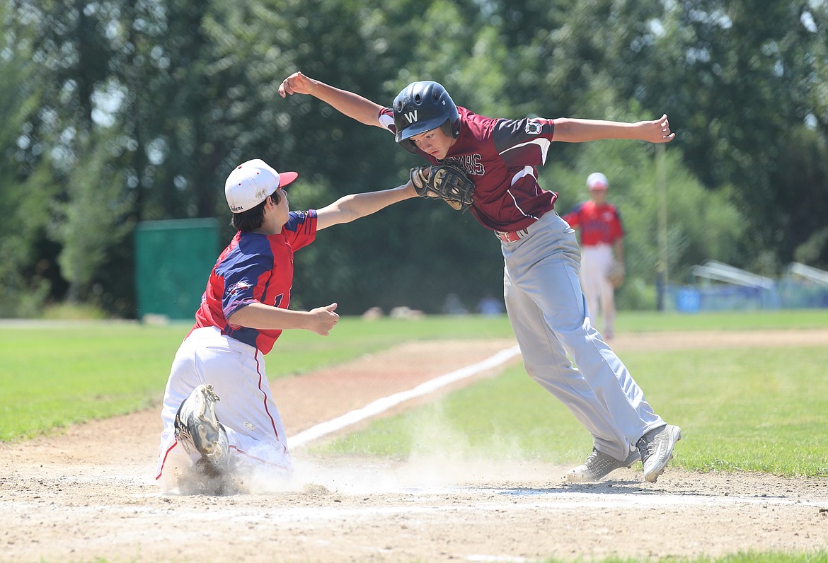 Cole Sanroman tags out a Whitman County runner at home on Friday.