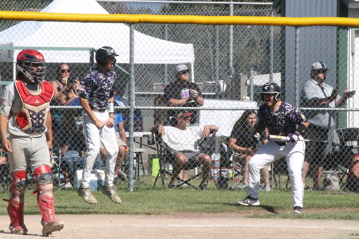 MARK NELKE/Press
Jacob Schaffner, left, and Scott Pote celebrate after Schaffner and Tanner Vandever scored on a dropped fly ball in the seventh inning to give Northern Lakes the lead over Camas Prairie in an Idaho Class A Area A (district) tournament game Friday at Gorton Field in Rathdrum.